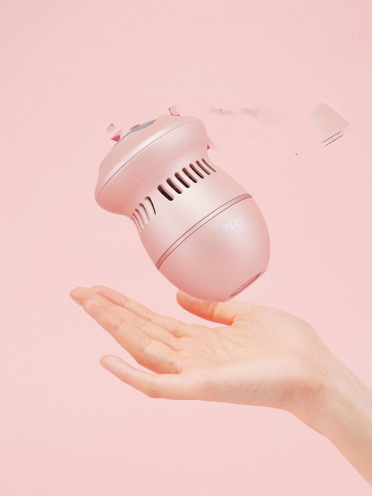Multifunctional Electric Foot File Grinder Machine held in a hand with a pink background.